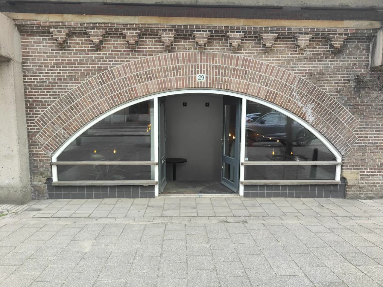 Studio 29 from the street: a brick railway arch with the number 29 above a glass frontage and an open door