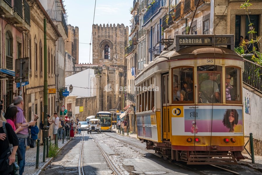View of vintage tram and Lisbon Cathedral in Alfama, Alfama District, Lisbon, Portugal, Europe