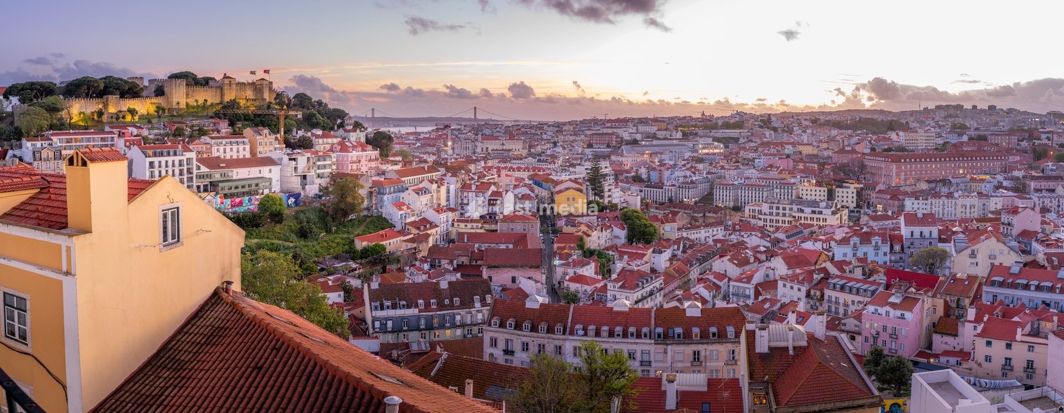 Panoramic view of Lisbon Castle from Miradouro da Senhora do Monte scenic point at dusk in the Alfama District, Lisbon, Portugal, Europe