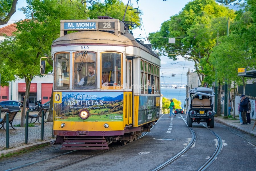 View of vintage tram and colourful buildings in the Alfama District on a sunny day, Lisbon, Portugal, Europe