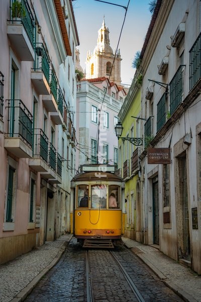 View of vintage tram and colourful buildings in the Alfama District on a sunny day, Lisbon, Portugal, Europe