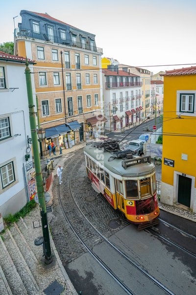 View of vintage tram and colourful buildings in the Alfama District on a sunny day, Lisbon, Portugal, Europe