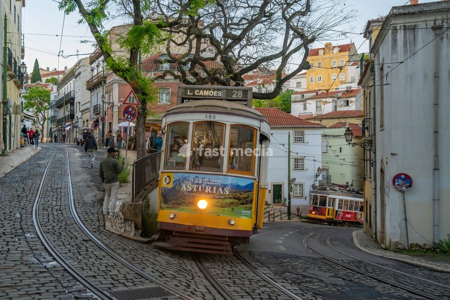 View of vintage tram and colourful buildings in the Alfama District on a sunny day, Lisbon, Portugal, Europe
