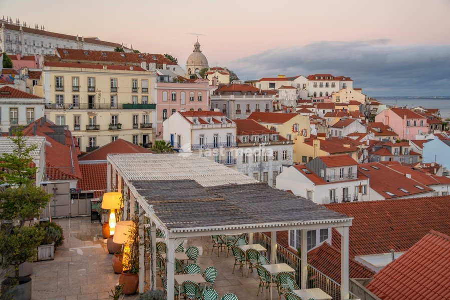 View of colourful buildings and red rooftops at sunset in the Alfama District, Lisbon, Portugal, Europe