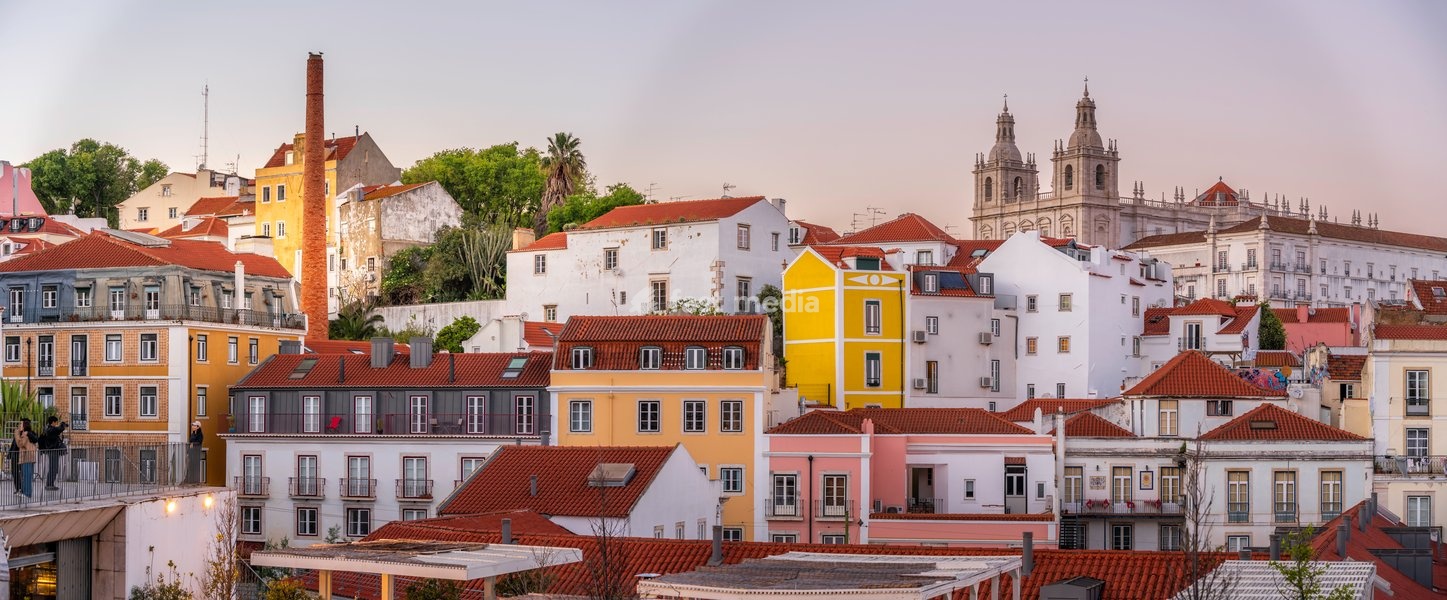 View of colourful buildings and red rooftops at sunset in the Alfama District, Lisbon, Portugal, Europe