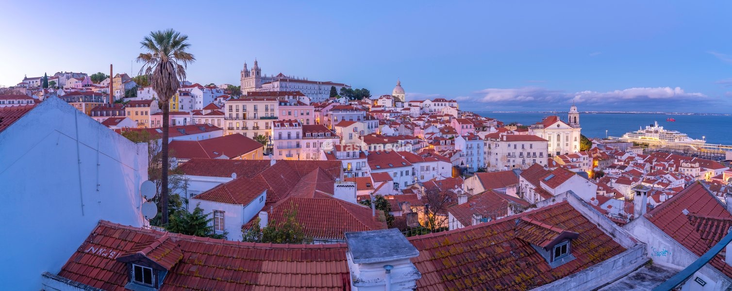 View of colourful buildings and red rooftops at dusk in the Alfama District, Lisbon, Portugal, Europe