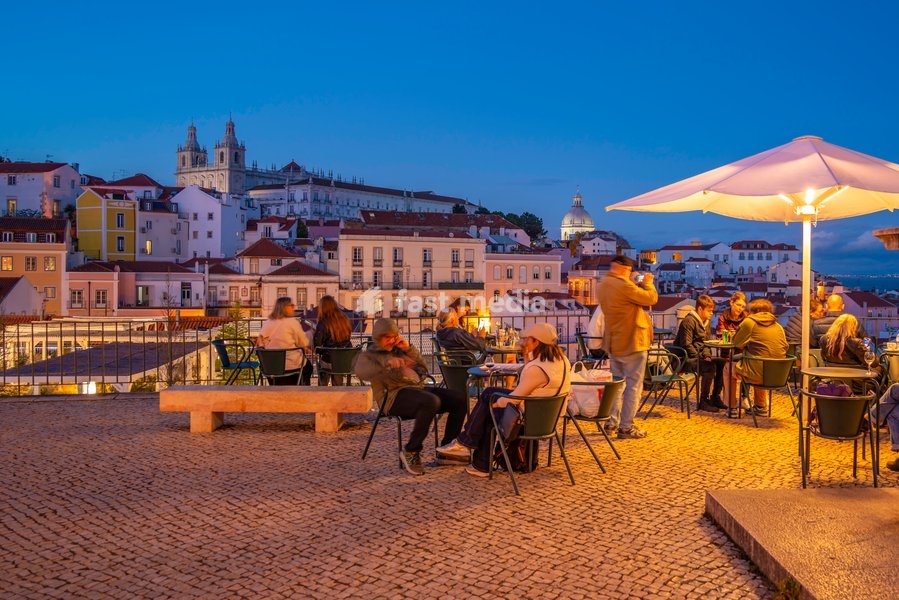 View of colourful buildings and red rooftops at dusk in the Alfama District, Lisbon, Portugal, Europe