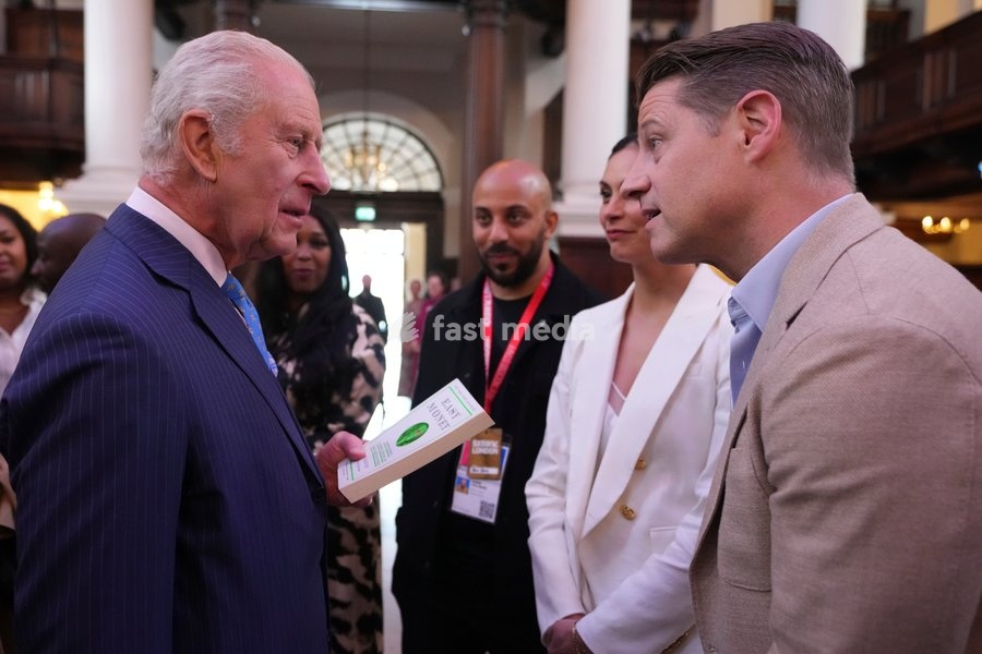 Britain's King Charles speaks to actor Ben McKenzie who handed the king his book, as he attends the South by SouthWest London (SXSW London), a culture, technology and creativity festival in Shoreditch, London, Thursday, June 5, 2025