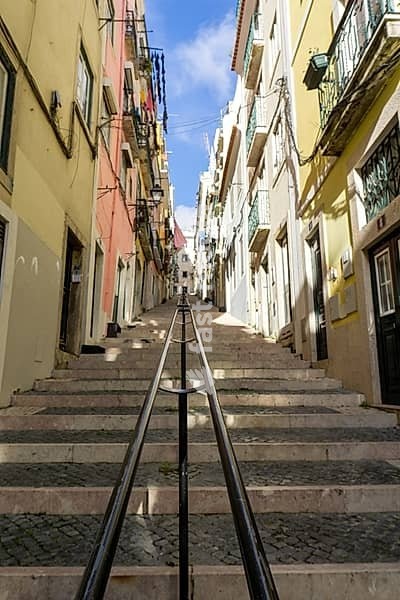 Lisbon, Portugal - 15 December 2020: stairs leading up a narrow alley in the historic city center of Lisbon
