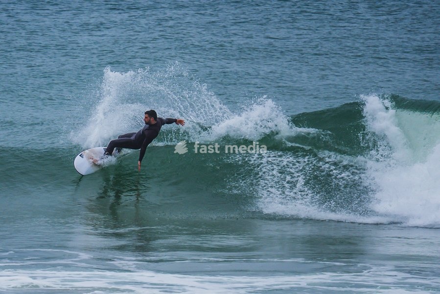 Surfers in popular beach of Supertubos, Peniche, Portugal