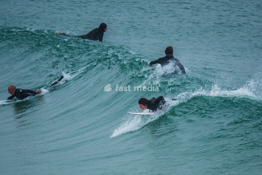 Surfers in popular beach of Supertubos, Peniche, Portugal