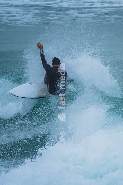 Surfers in popular beach of Supertubos, Peniche, Portugal