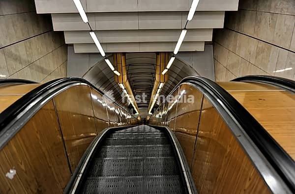 Prague, Czech Republic, Europe, Long escalator in a modern, symmetrical tunnel design