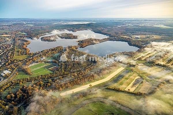 Aerial view, fog over the Haltern reservoir with distant view, surrounded by autumnal deciduous trees, Haltern town, Haltern am See, Ruhr area, Münsterland, North Rhine-Westphalia, Germany, fog, Haltern reservoir, distant view, autumnal, deciduous trees, nature, landscape, water, view, autumn,…