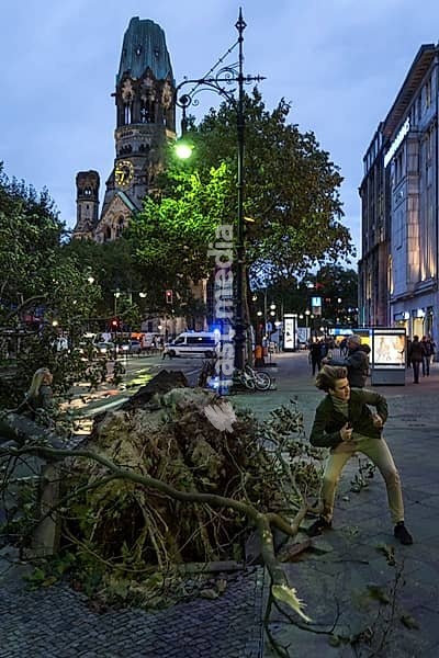 DEU Germany Germany Berlin Fire brigade operation on Kurfürstendamm. Storm Xavier had caused trees to fall onto the street. Passers-by pose for souvenir photos