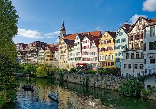 Historic houses on the Neckar front, the Neckar river with poking and water reflection, old town of Tübingen, Baden-Württemberg, Germany