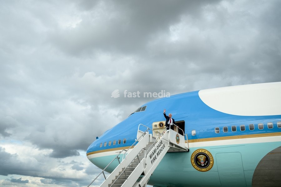 President Donald Trump waves to members of the media as he boards Air Force One at Miami International Airport, Wednesday, November 5, 2025