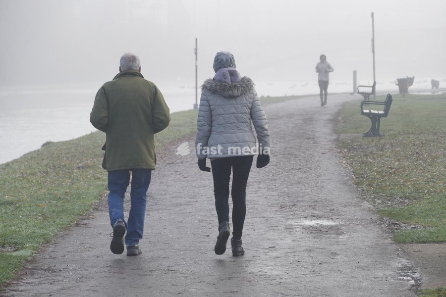 Walkers along The thames Path in the mist