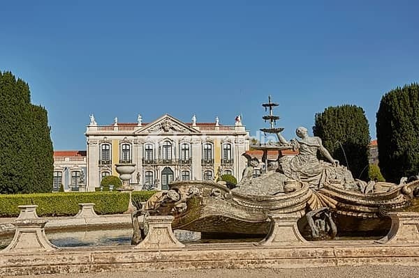 QUELUZ, SINTRA / PORTUGAL - OCOBER 02, 2017: Facade, fountain and gardens of Queluz Palace in Sintra, Portugal during summer day