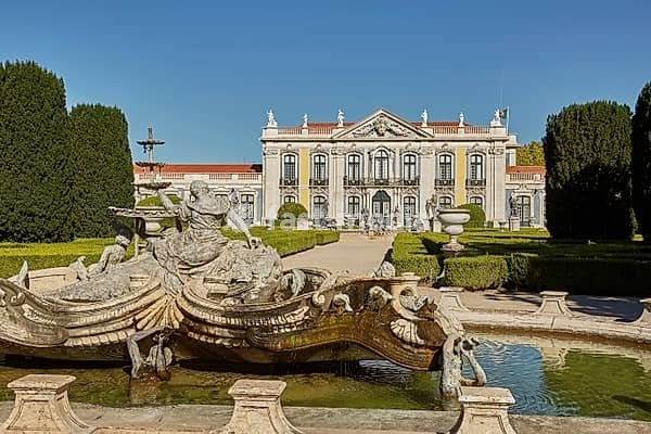 QUELUZ, SINTRA / PORTUGAL - OCOBER 02, 2017: Facade, fountain and gardens of Queluz Palace in Sintra, Portugal during summer day