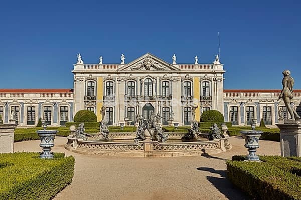 QUELUZ, SINTRA / PORTUGAL - OCOBER 02, 2017: Facade, fountain and gardens of Queluz Palace in Sintra, Portugal during summer day