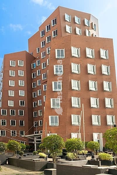 Modern red brick deconstructivist architecture of the Neuer Zollhof building by Frank Gehry in Düsseldorf Germany