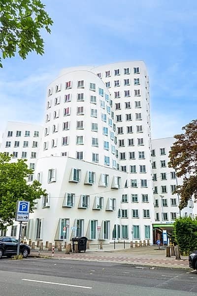 Modern white deconstructivist architecture of the Neuer Zollhof building by Frank Gehry in Düsseldorf Germany