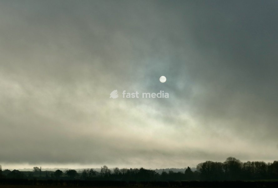 The sun burns through the mornings light mist over the countryside