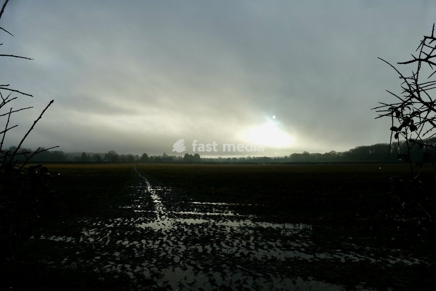 The sun burns through the mornings light mist over the countryside