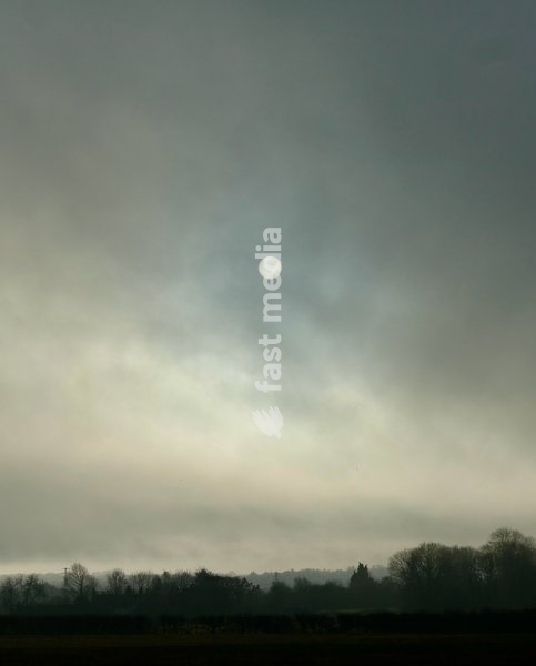 The sun burns through the mornings light mist over the countryside