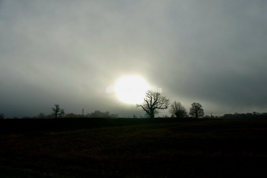 The sun burns through the mornings light mist over the countryside