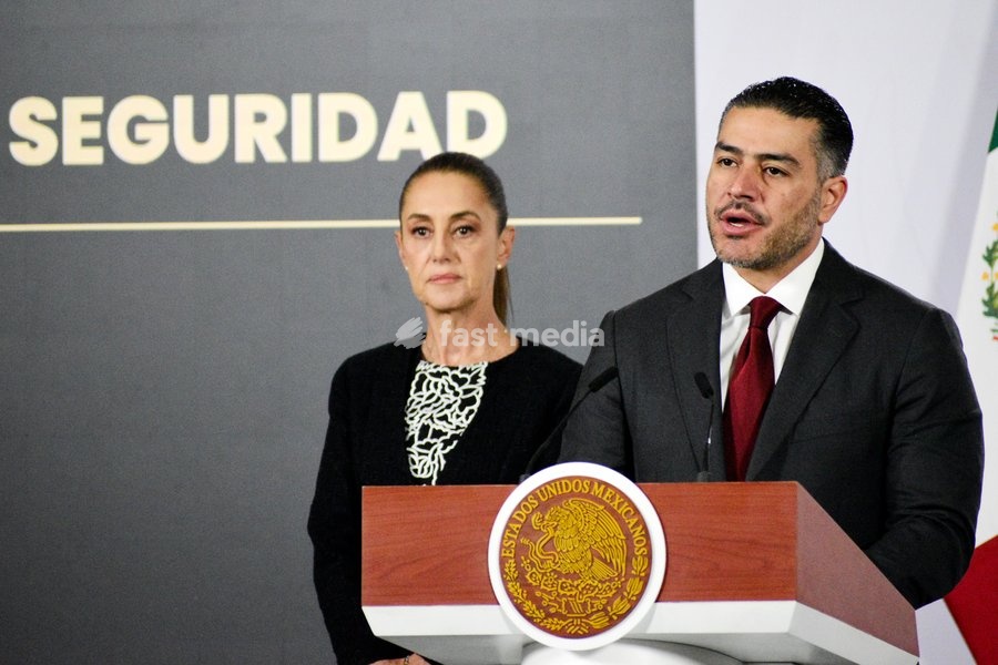Mexico’s President Claudia Sheinbaum Pardo is seen behind while the Secretary of Security and Citizen Protection, Omar Garcia Harfuch, speaking during a briefing conference on the monthly security report at National Palace. on February 10, 2026 in Mexico City, Mexico