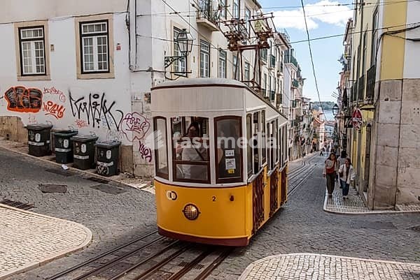 Lisboa, Portugal - June 04, 2024 - Iconic historic Ascensor da Bica in old town Lisboa, Portugal, Tajo river in the background