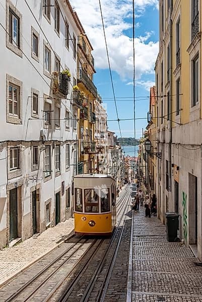 Iconic historic Ascensor da Bica in old town Lisbon, Portugal, Tajo river in the background