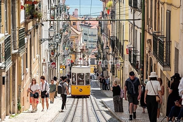 Lisboa, Portugal - June 04, 2024 - Iconic historic Ascensor da Bica in old town Lisboa, Portugal, Tajo river in the background