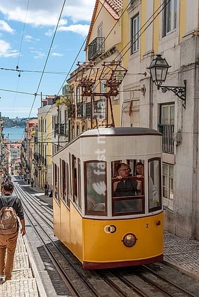 Lisboa, Portugal - June 04, 2024 - Historical Ascensor da Bica in old town Lisboa, Portugal, Tajo river in the background