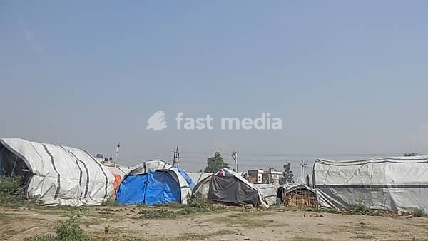 Tents as temporary dwellings after the earthquake in Kathmandu with tarps under a clear sky, Kathmandu, Nepal