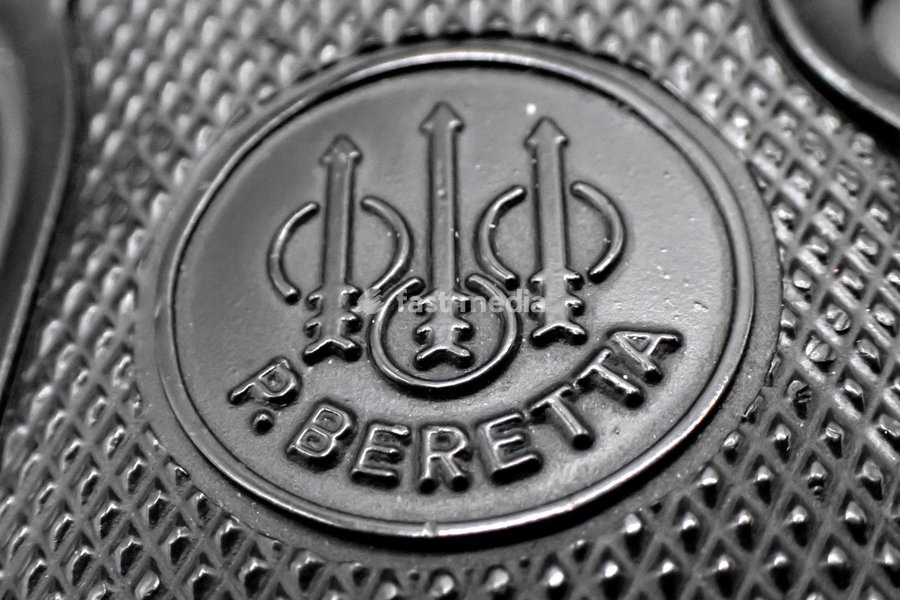 In this illustration photo. The Beretta logo is stamped on the stock of the Beretta 98 ​​FS pistol in 9x21mm caliber, manufactured by the Pietro Beretta arms factory