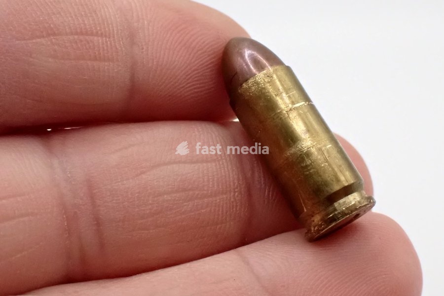 In this illustration photo. A 9x21mm pistol bullet in a man's hands