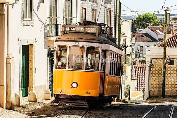Yellow Tram 28 in Historic Neighborhood Alfama on Sunny Day. Lisbon, Portugal