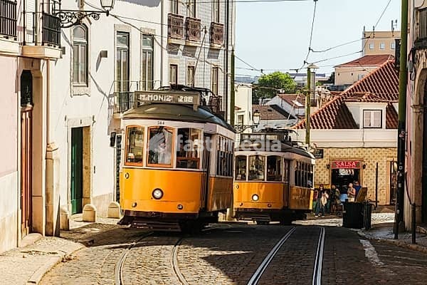 LISBON, PORTUGAL - APRIL 3, 2026: Tram 28 in Historic Neighborhood Alfama on Sunny Day. Lisbon, Portugal