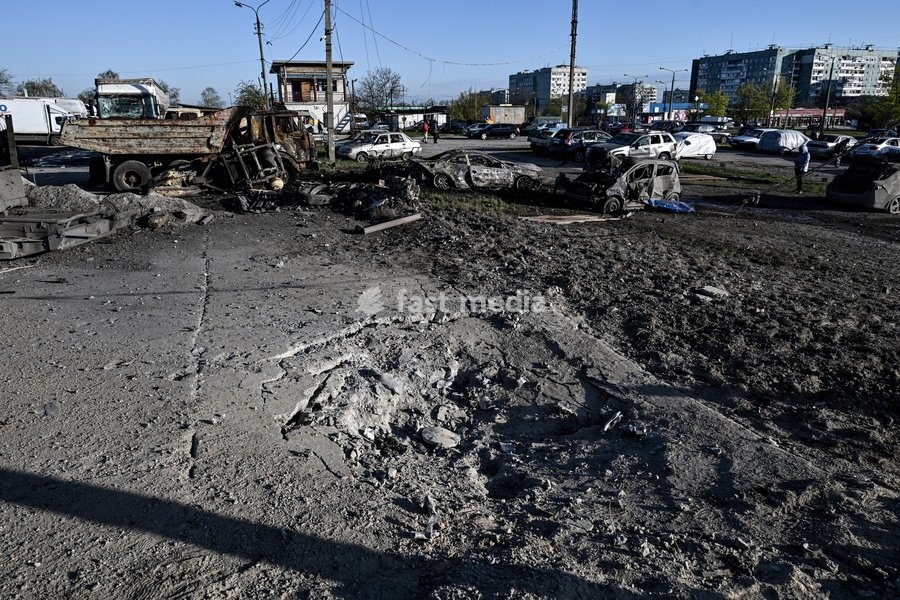 A place of impact is pictured at a parking lot after a Russian drone strike in Zaporizhzhia, Ukraine, April 15, 2026. The attack killed a 74-year-old woman and damaged the stop, a parking lot, and nearby residential buildings