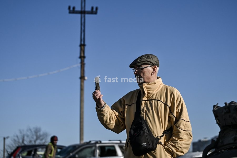 A man stands at a parking lot hit by Russian drones in Zaporizhzhia, Ukraine, April 15, 2026. The attack killed a 74-year-old woman and damaged the stop, a parking lot, and nearby residential buildings