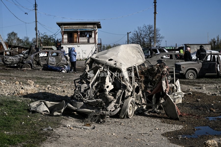 A car destroyed by a Russian drone strike is at a parking lot in Zaporizhzhia, Ukraine, April 15, 2026. The attack killed a 74-year-old woman and damaged the stop, a parking lot, and nearby residential buildings