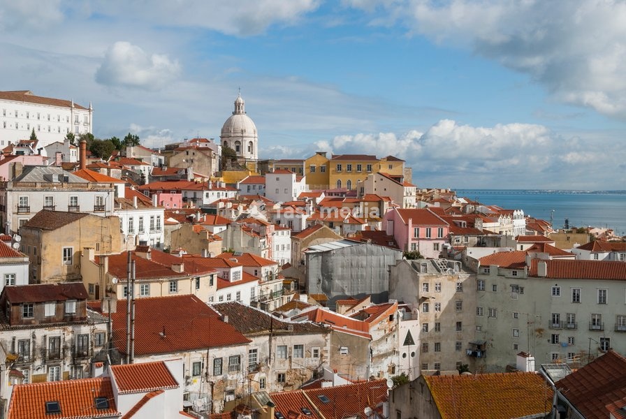 Overview of Alfama district showing rooftops and buildings from belvedere Portas do Sol in Lisbon Portugal during a sunny day