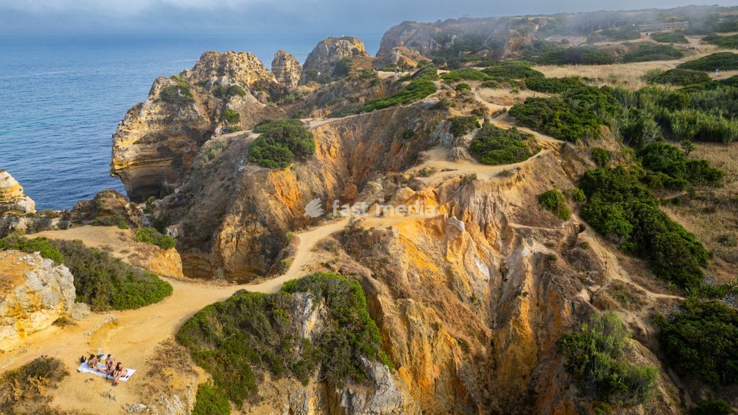 Sunset view of cliffs and beach in Lagos along the Algarve coast in Portugal