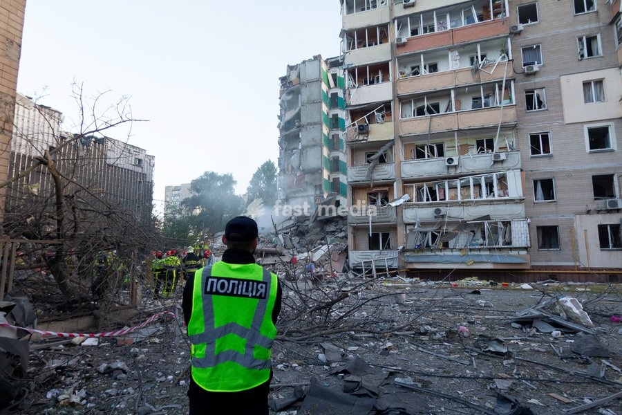 A police officer watches rescuers work at nine-storey apartment blocks damaged by a Russian missile and drone strike in Kyiv, Ukraine, on May 14, 2026. Russia launched a massive attack on the Ukrainian capital, deploying more than 670 strike drones and 56 missiles of various types. The attack…