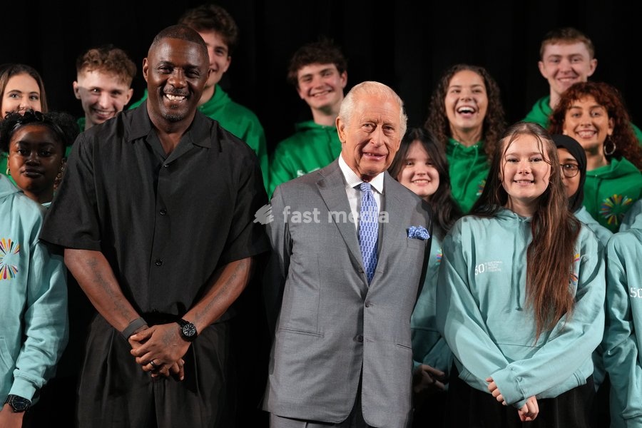 Britain's King Charles III joins English actor Idris Elba in meeting students taking part in workshops organised by National Youth Music Theatre (NYMT) at The Other Palace in London, Thursday, May 14, 2026