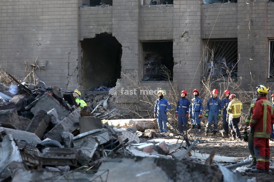 Rescuers from the State Emergency Service watch a response effort outside a nine-storey apartment block damaged by a Russian missile and drone strike in Kyiv, Ukraine, on May 14, 2026. Russia launched a massive attack on the Ukrainian capital, deploying more than 670 strike drones and 56 missiles…