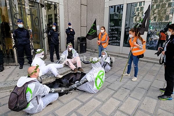 Belgium, Brussel, April 1, 2021: demonstration of the global environmental movement Extinction Rebellion in front of the headquarters of EuroClear, to protest against the role of the banking and finance sector in the climate crisis, Sint-Joost-Ten-Node, Saint-Josse-ten-Noode, Brussels-Capital,…